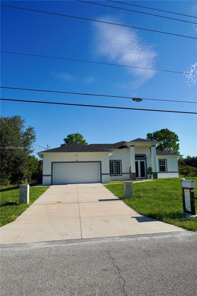 Front exterior of a new home in , Lehigh Acres, FL, highlighting curb appeal (Image 19).