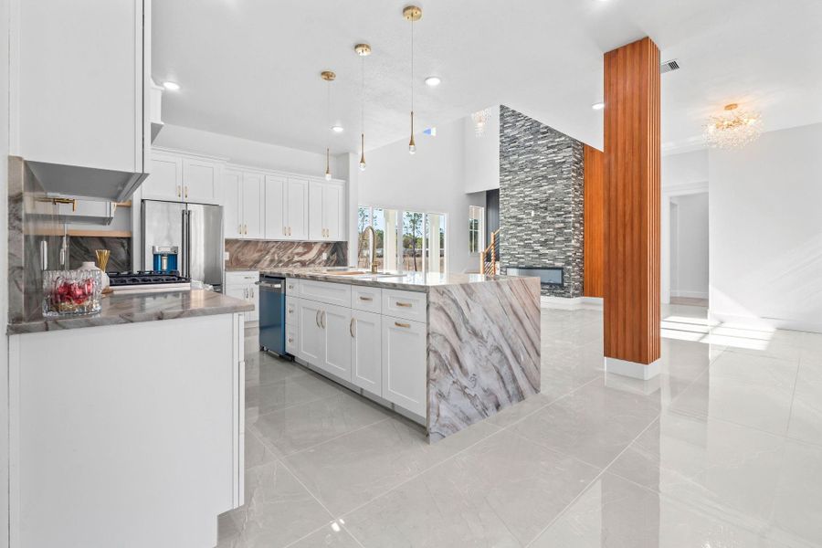 All wood cabinets with gold handles. Need more space? The walk-in butlers' room is behind the kitchen