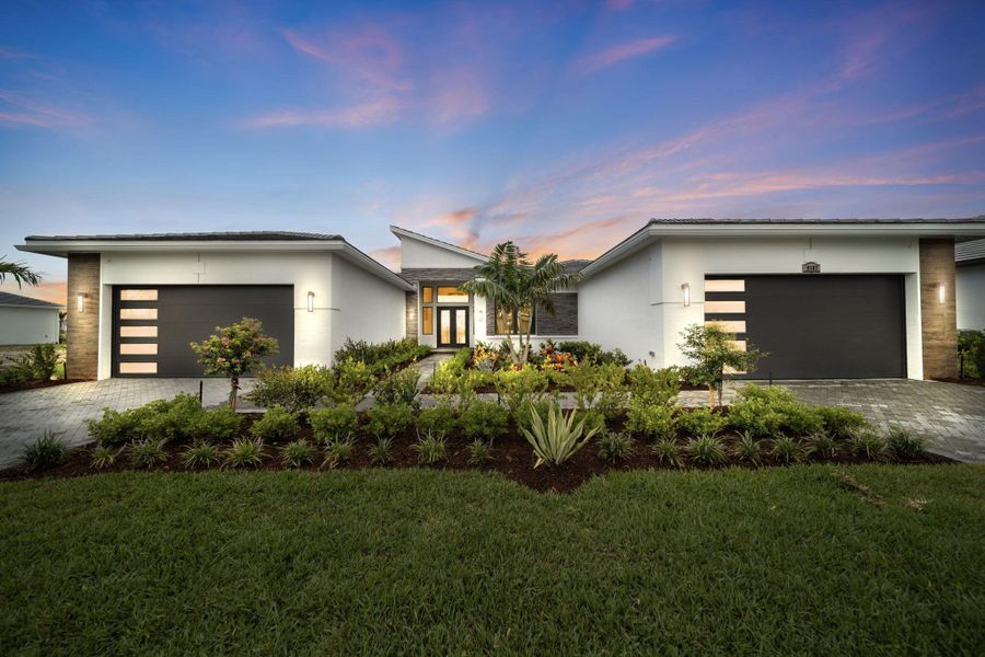 Front exterior of a new home in Astor Creek Golf & Country Club, Port St. Lucie, FL, highlighting curb appeal (Image 1).