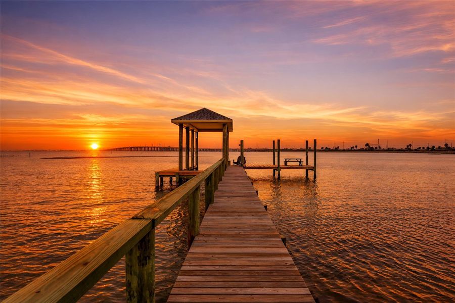 Sunsets become part of the routine here. End the day at the private pier as color moves across the bay, then retreat home without ever leaving your property. Sunsets become part of the routine here. End the day at the private pier as color moves across the bay, then retreat home without ever leaving your property.