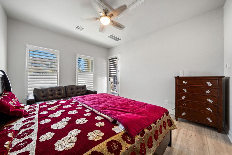 Bedroom featuring light wood-type flooring, a ceiling fan, and access to outside