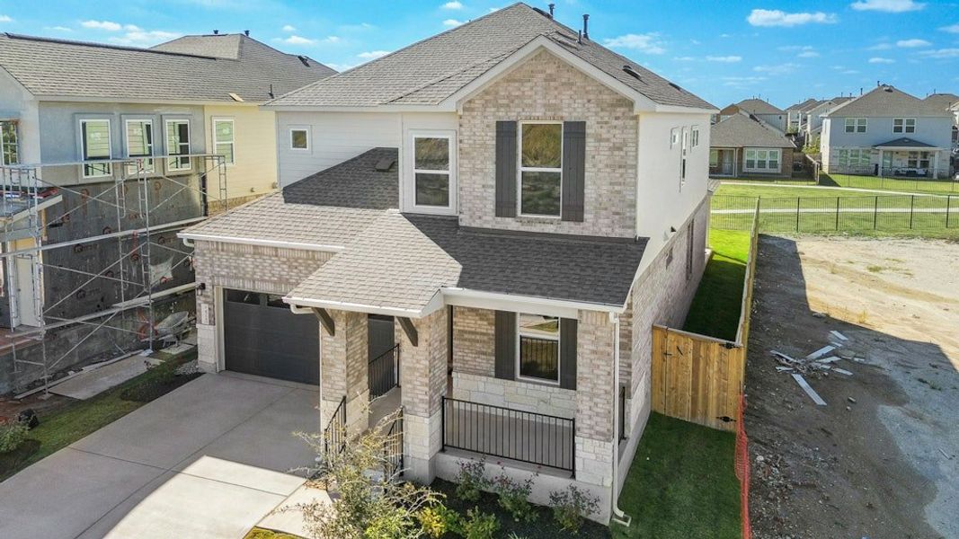 Front exterior of a new home in University Heights, Round Rock, TX, highlighting curb appeal (Image 21).