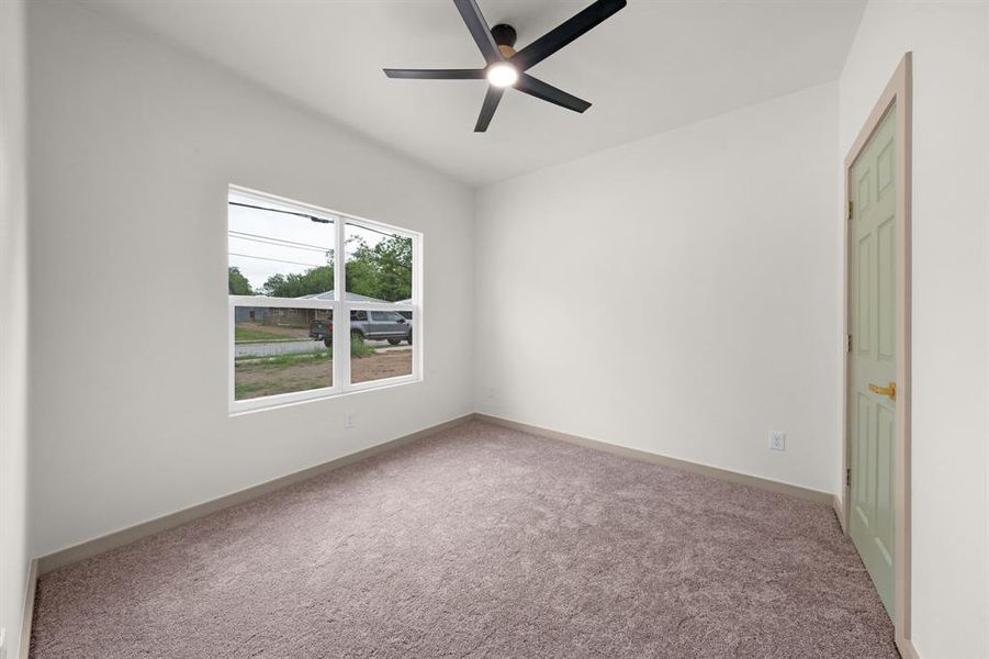 Unfurnished bedroom with carpet flooring, a ceiling fan, and baseboards