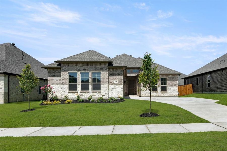 French provincial home featuring roof with shingles, brick siding, stone siding, and concrete driveway French provincial home featuring roof with shingles, brick siding, stone siding, and concrete driveway