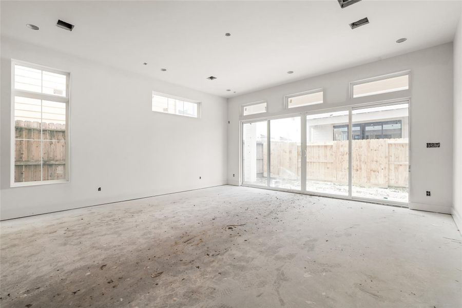 Living room with oversized sliding glass door opens to your covered patio and backyard, while letting in lots of natural light.
