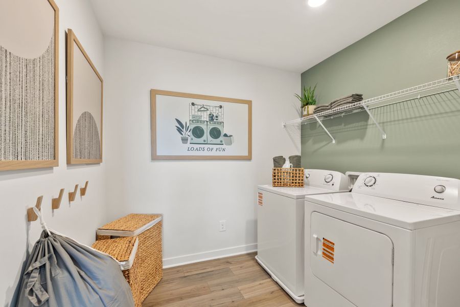 A white laundry room with a washer and dryer. A white laundry room with a washer and dryer.