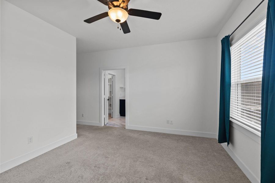 Primary bedroom has nice big windows, ceiling fan and ensuite bathroom.