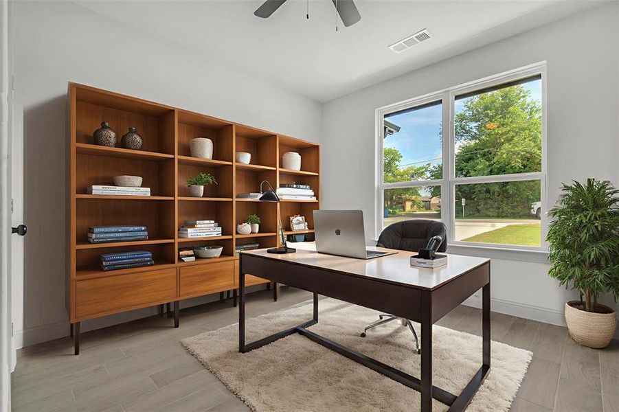 Office area with a ceiling fan, healthy amount of natural light, and light wood-style floors, virtually staged Office area with a ceiling fan, healthy amount of natural light, and light wood-style floors, virtually staged