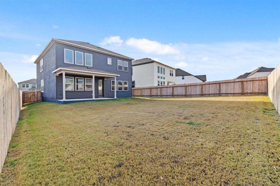 Rear view of property featuring a yard