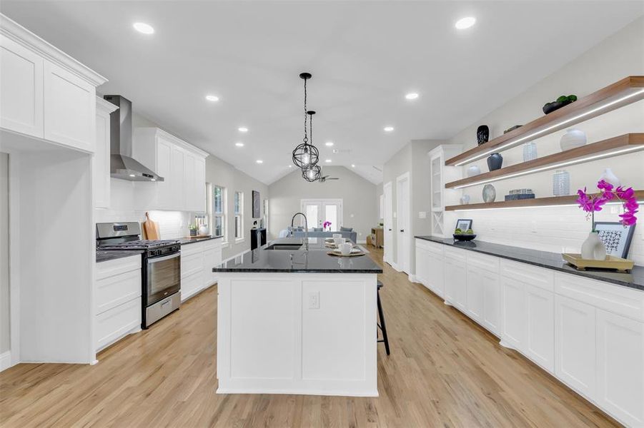 Kitchen with backsplash, open shelves, white cabinets, recessed lighting, and vaulted ceiling