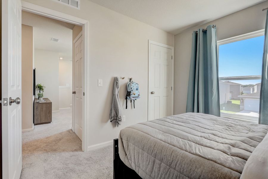 A bedroom with a large window.