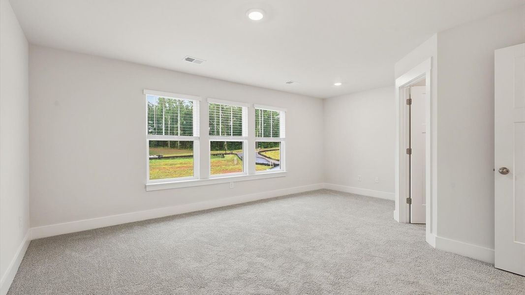 Elegant primary suite with natural light and walk-in closet in this top-notch Aspen Ridge villa