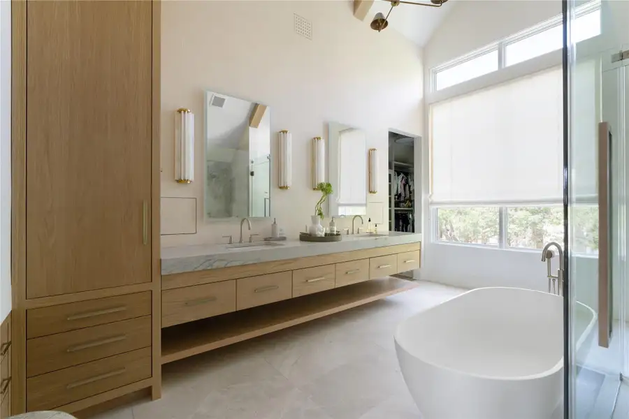 Spa-inspired primary bathroom with soaking tub, dual vanities, and large windows for natural light.*Images depict previously completed homes by Roberson Building Group and are intended solely to showcase builder quality and craftsmanship.