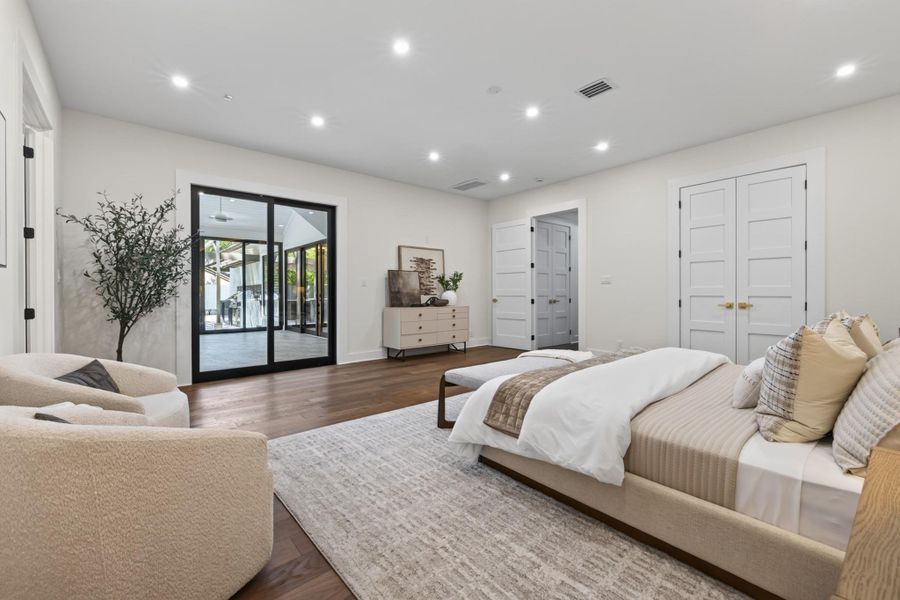 Alternate view of the primary suite highlights its impressive scale and private setting.