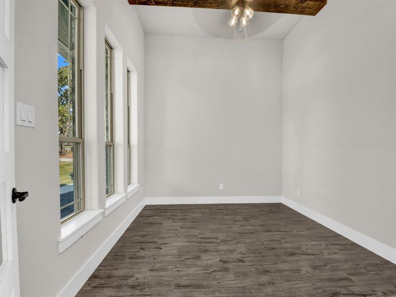 Spare room featuring a ceiling fan and dark wood finished floors
