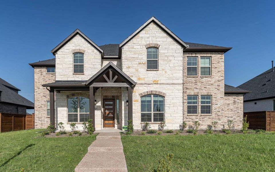 Front exterior of a new home in Solterra, Mesquite, TX, highlighting curb appeal (Image 1).