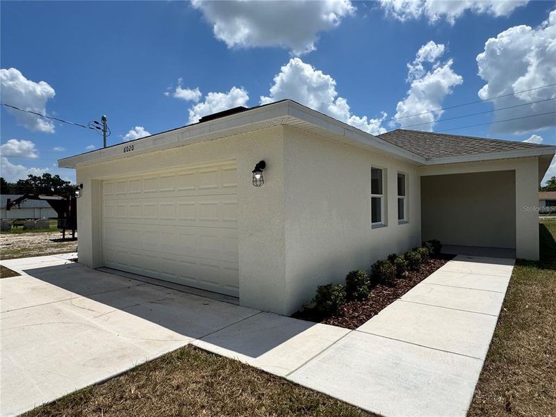 Front exterior of a new home in , Zephyrhills, FL, highlighting curb appeal (Image 24). Front exterior of a new home in , Zephyrhills, FL, highlighting curb appeal (Image 24).