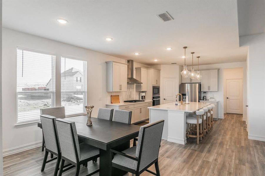 Dining space with a healthy amount of sunlight, wood-type flooring, and sink