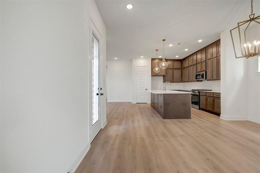 Open-concept living area with wood-finish flooring