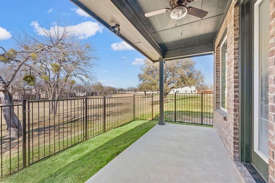 Fenced backyard featuring a patio and ceiling fan