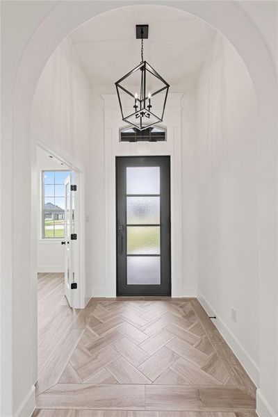 Entrance foyer featuring arched walkways and a chandelier Entrance foyer featuring arched walkways and a chandelier