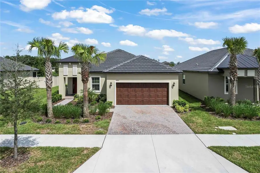 Front exterior of a new home in Angeline Active Adult, Land O' Lakes, FL, highlighting curb appeal (Image 1). Front exterior of a new home in Angeline Active Adult, Land O' Lakes, FL, highlighting curb appeal (Image 1).