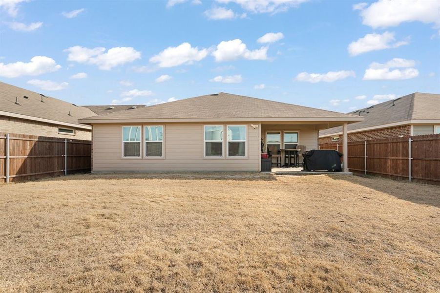 Rear view of house featuring a patio and a fenced backyard Rear view of house featuring a patio and a fenced backyard