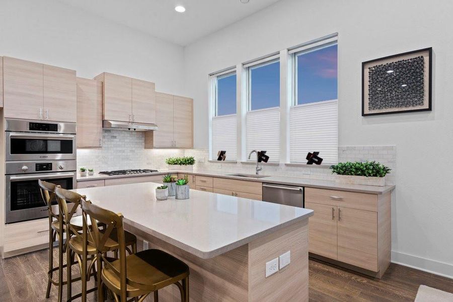Kitchen featuring light brown cabinetry, tasteful backsplash, dark wood-style floors, light stone counters, and recessed lighting