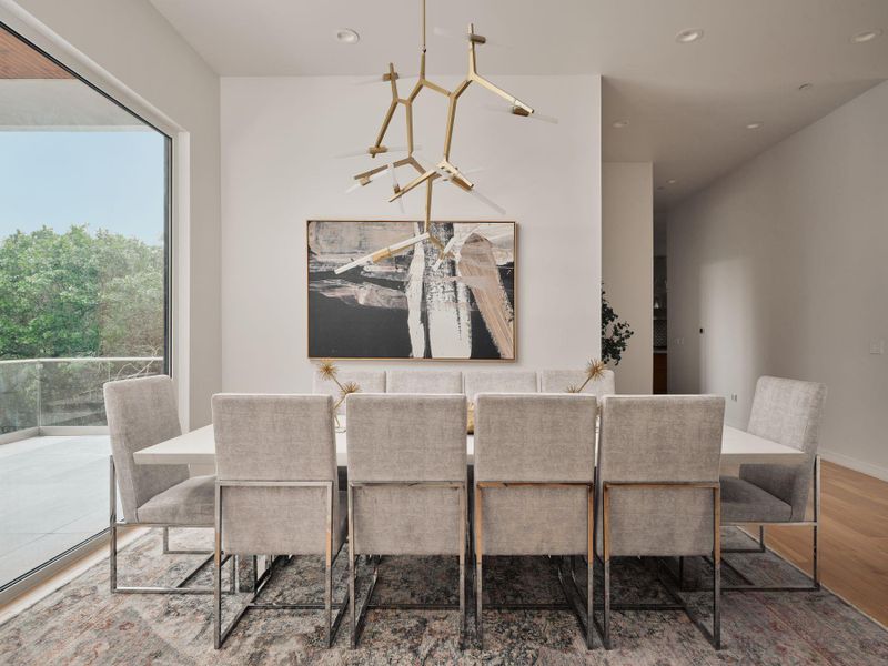 Elegant dining space featuring a unique chandelier and ample natural illumination from the adjacent patio. Elegant dining space featuring a unique chandelier and ample natural illumination from the adjacent patio.