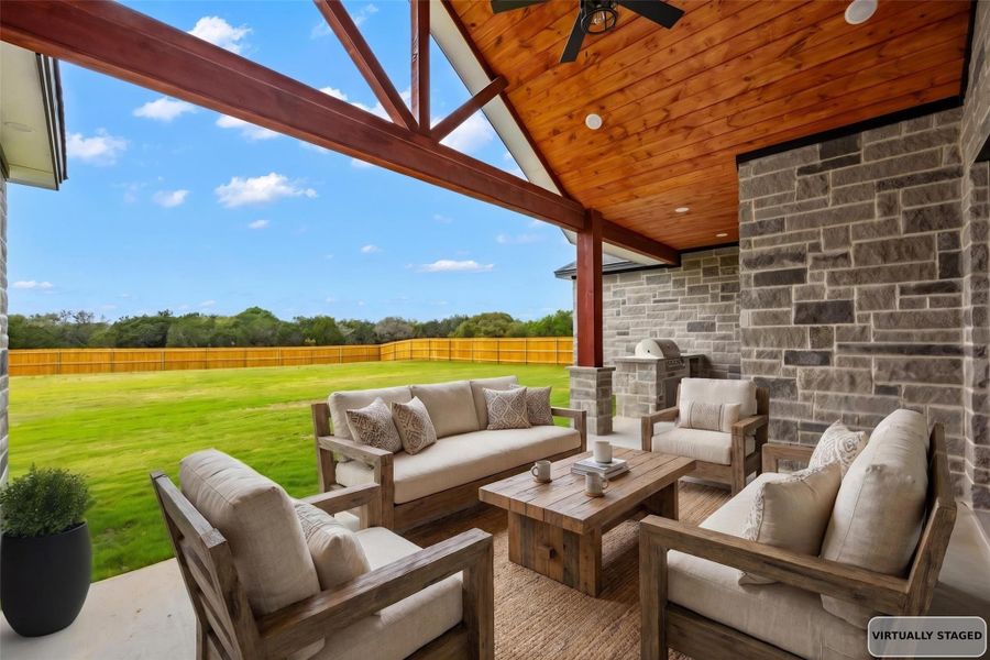 Covered patio featuring a high vaulted wood-finish ceiling with exposed beams, recessed lighting, and a ceiling fan