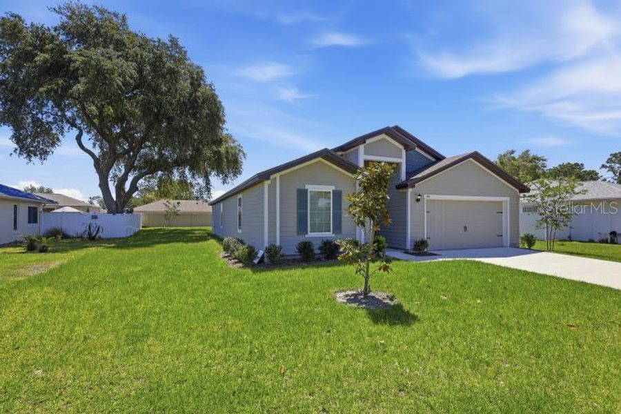 Front exterior of a new home in Palm Coast, Palm Coast, FL, highlighting curb appeal (Image 20).