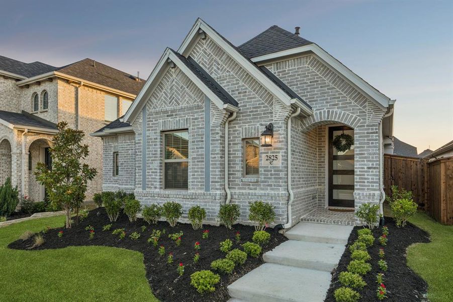 Front exterior of a new home in Cambridge Crossing, Celina, TX, highlighting curb appeal (Image 22).