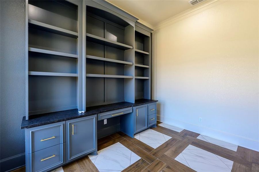 Unfurnished office featuring baseboards and ornamental molding Unfurnished office featuring baseboards and ornamental molding