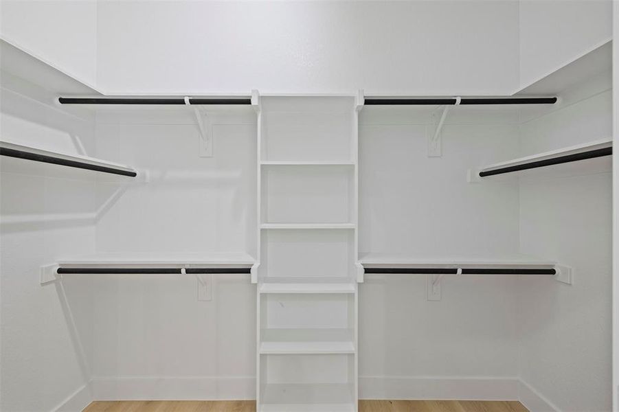 Spacious closet with light wood-style floors