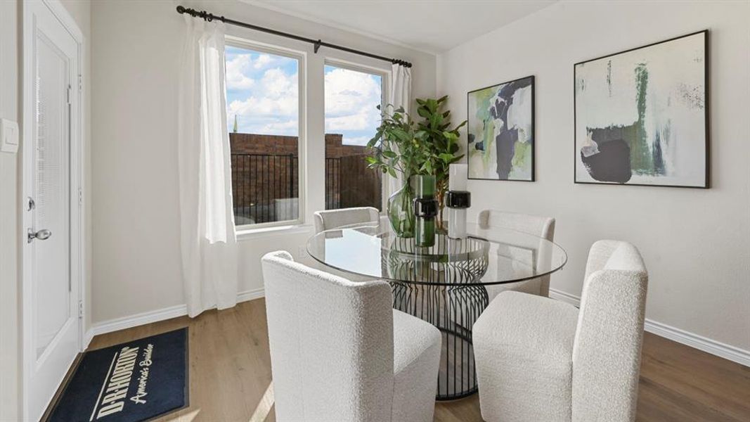 Dining space with wood finished floors and baseboards