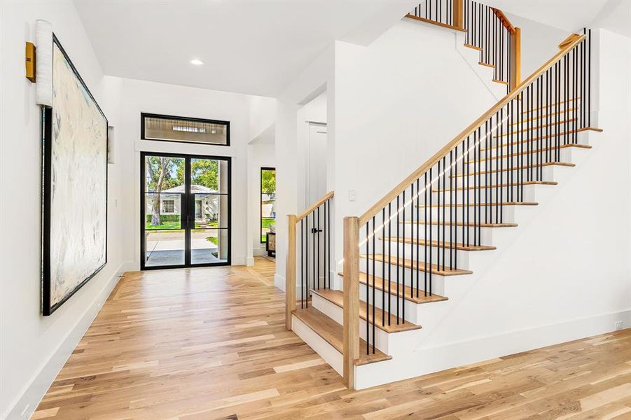 Entryway with stairway, light wood-type flooring, and recessed lighting Entryway with stairway, light wood-type flooring, and recessed lighting