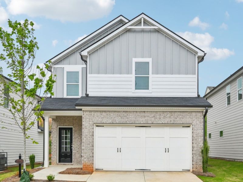 Front exterior of a new home in Hawthorne Station, Atlanta, GA, highlighting curb appeal (Image 1).
