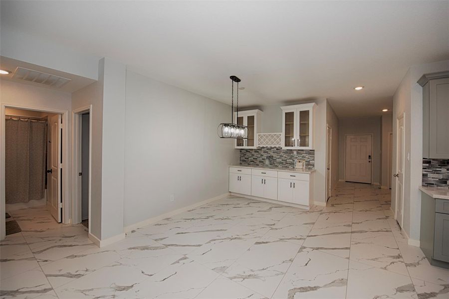 Another view of the formal dining room showing the tremendous space as well as the stunning porcelain tiled floors. Another view of the formal dining room showing the tremendous space as well as the stunning porcelain tiled floors.
