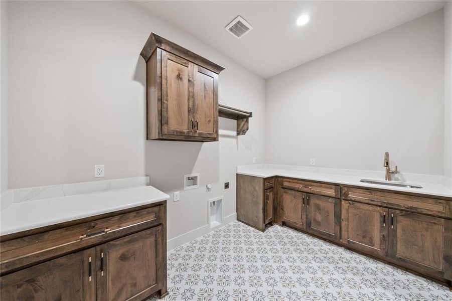 Laundry area with washer hookup, hookup for a gas dryer, cabinet space, electric dryer hookup, and recessed lighting