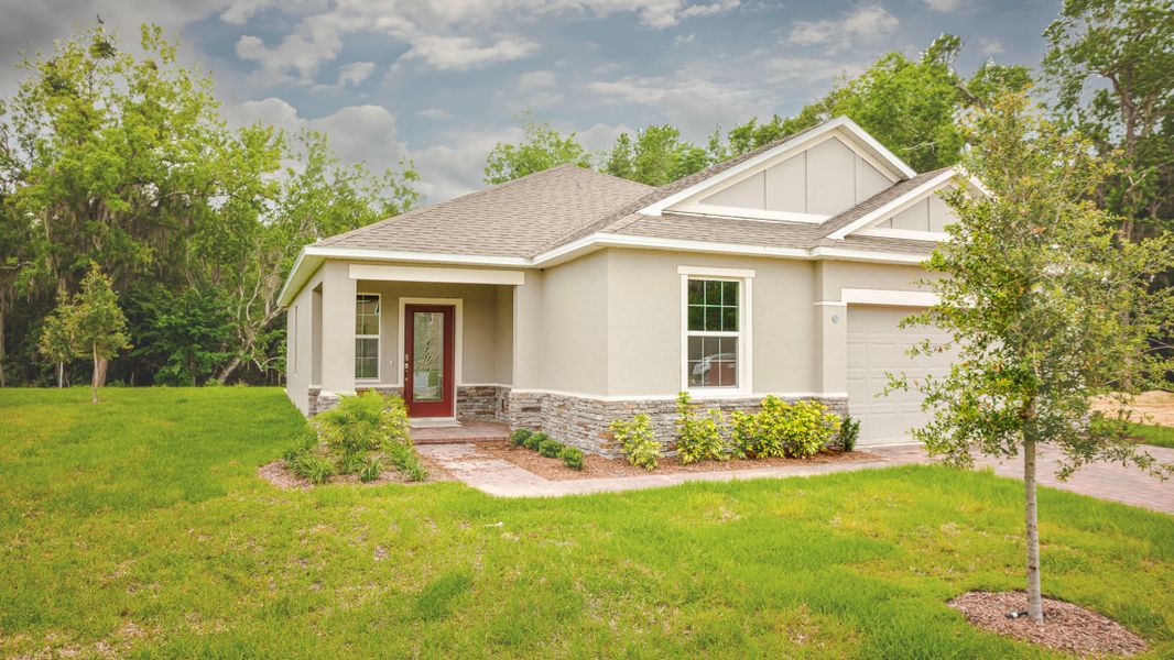 Front exterior of a new home in Villa Pass, Mascotte, FL, highlighting curb appeal (Image 16).