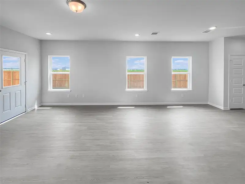 The Waring III- Dining Area and Family Room. Sample image for illustration; upgrades, options, and colors may vary.