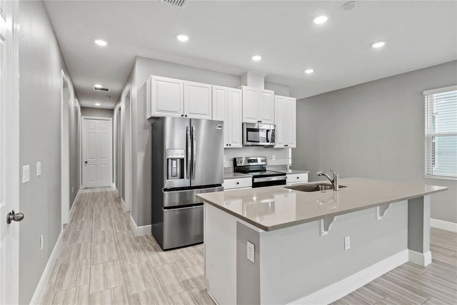 Kitchen with 42" cabinets, quartz countertops and stainless steel appliances