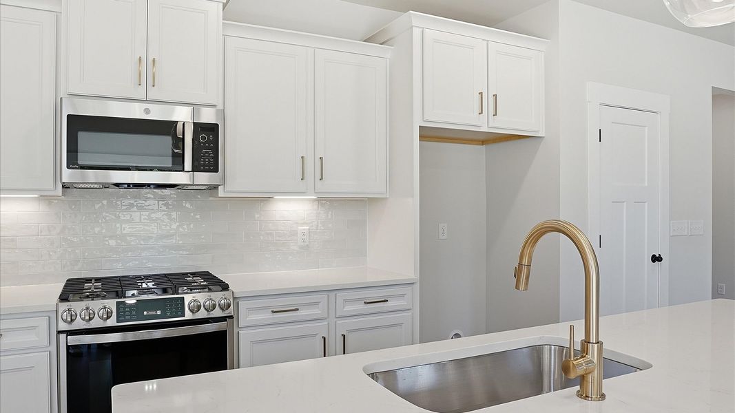 Elegant kitchen with modern finishes in this first-class home at Benjamin's Grove in Woodruff, SC Elegant kitchen with modern finishes in this first-class home at Benjamin's Grove in Woodruff, SC
