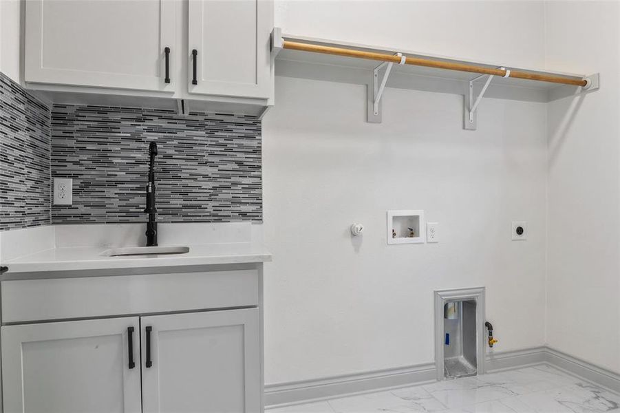 Laundry room featuring gas/electric dryer hookup, hookup for a washing machine, finish flooring, and hookup for an electric dryer Laundry room featuring gas/electric dryer hookup, hookup for a washing machine, finish flooring, and hookup for an electric dryer