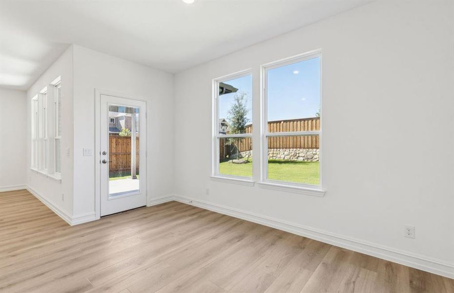 Dining nook off kitchen with large windows