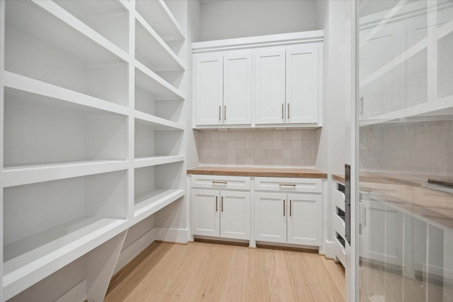 Spacious pantry with under-cabinet electrical outlets and work space.