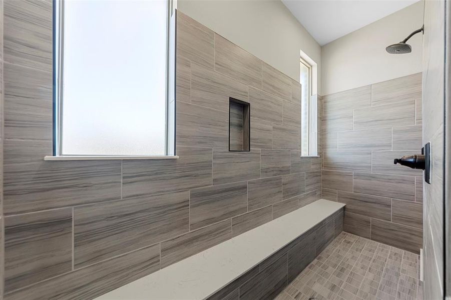 Full bathroom featuring tiled shower Full bathroom featuring tiled shower