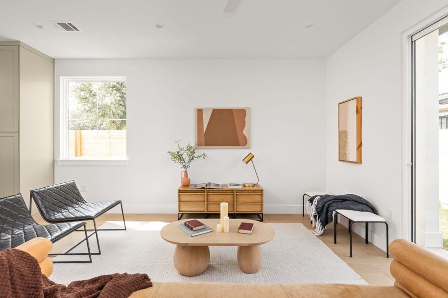 Living area featuring light wood-style flooring and plenty of natural light