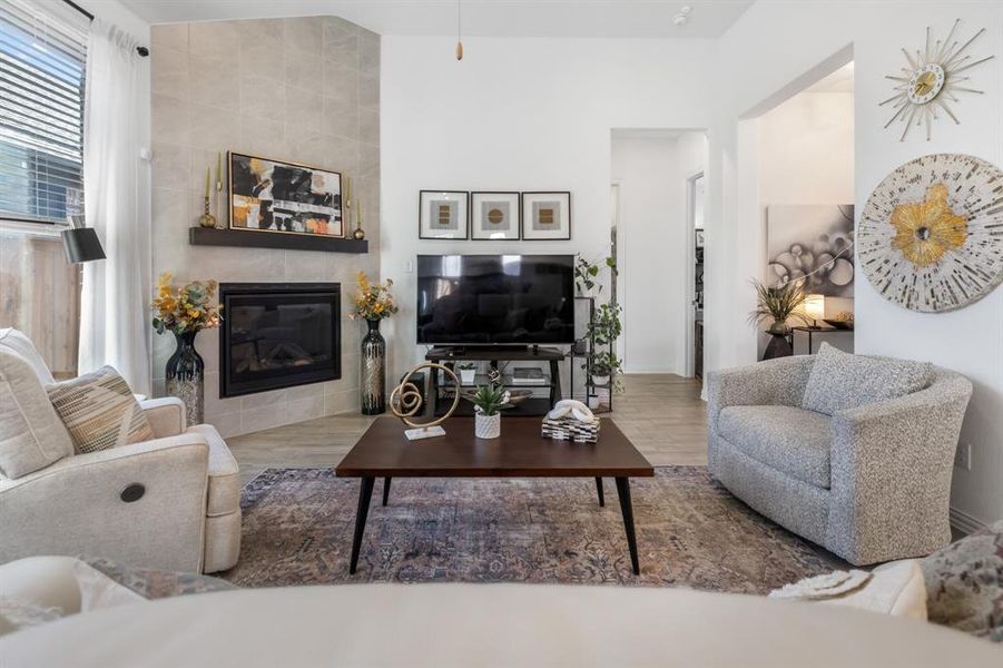 Living room with wood finished floors and a tile fireplace Living room with wood finished floors and a tile fireplace