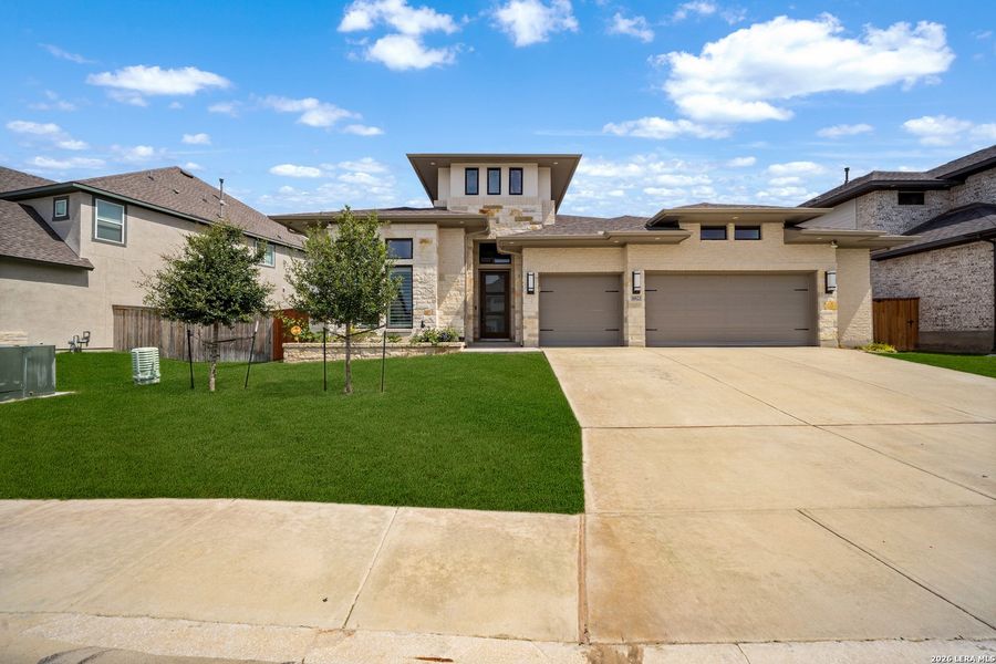 Front exterior of a new home in Ladera, San Antonio, TX, highlighting curb appeal (Image 1). Front exterior of a new home in Ladera, San Antonio, TX, highlighting curb appeal (Image 1).